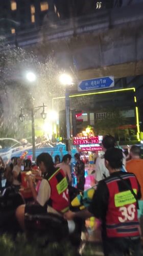 Bangkok street crowds celebrate Songkran with water truck festivities