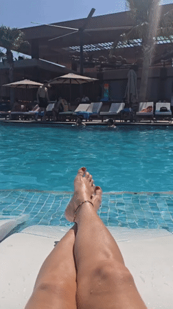 Woman relaxes poolside in leopard bikini in Northern Cyprus