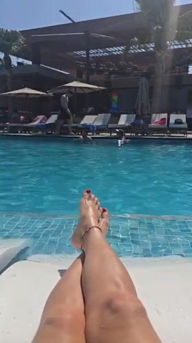 Woman relaxes poolside in leopard bikini in Northern Cyprus
