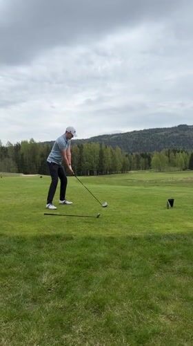 Golfer plays under overcast skies in Sylling, Norway
