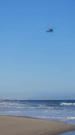 LAPD helicopter patrols above busy Santa Monica Beach