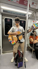 Street musician performs guitar on Buenos Aires subway
