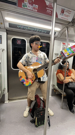 Street musician performs guitar on Buenos Aires subway