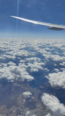 Airplane passenger documents flight views over Russian landscape