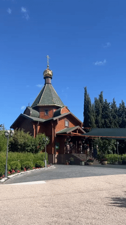 Roses bloom near wooden Orthodox church in Sevastopol