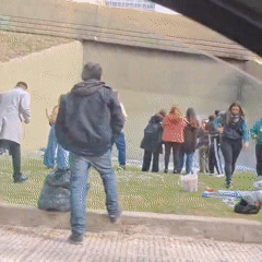 People gather, collect items near concrete structure in Buenos Aires