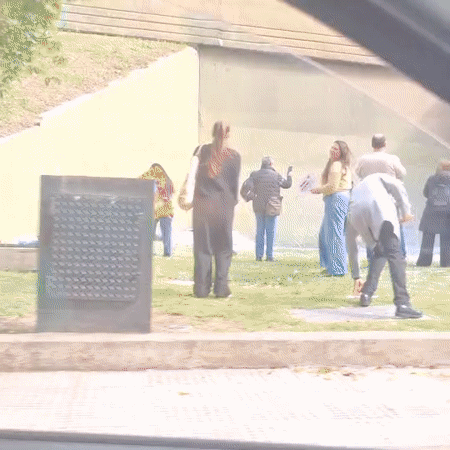 People gather, collect items near concrete structure in Buenos Aires