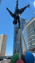 Public handstand sculpture observed in sunny Moscow morning