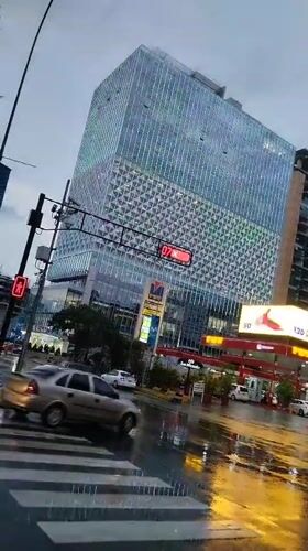 Evening rainstorm creates reflective streets in downtown Caracas