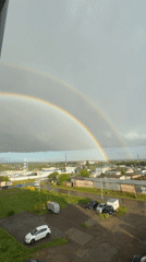 Double rainbow breaks over storm clouds in Zav'yalovo