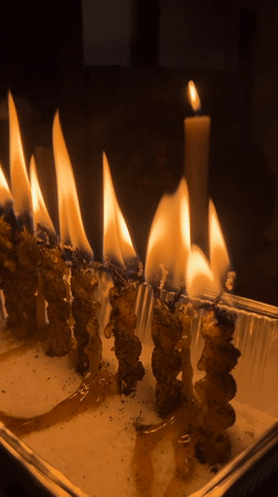 Ritual candles and occult objects arranged indoors in Tychy