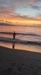 Colorful sunrise captured at Đà Nẵng beach with mountain backdrop
