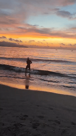 Colorful sunrise captured at Đà Nẵng beach with mountain backdrop