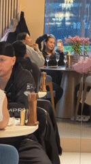 Diners gather at Moscow restaurant, woman takes selfie