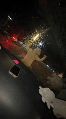 Young people hang out in car during rainy night