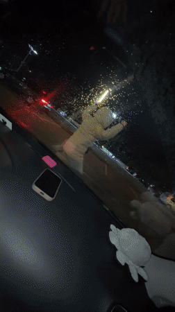 Young people hang out in car during rainy night