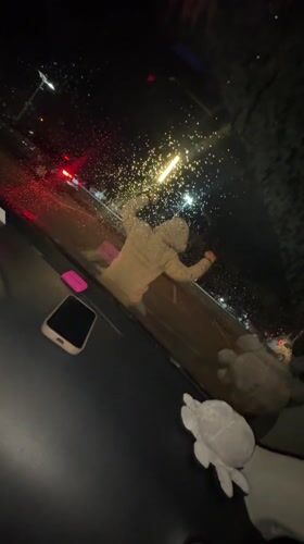 Young people hang out in car during rainy night