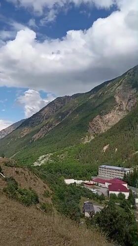 Mountain village life in Neitrino, Russia — infrastructure, livestock, and alpine scenery