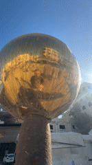 Golden sculpture and quiet street life in Gaza