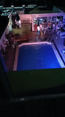 Nighttime gathering at outdoor pool draws crowd