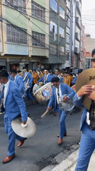 Traditional parade with marching band proceeds through La Paz streets