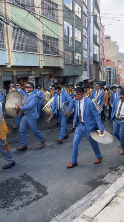 Traditional parade with marching band proceeds through La Paz streets