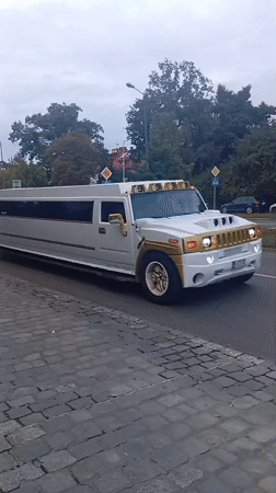 Gold-trimmed stretch Hummer navigates Wrocław's cobblestone streets