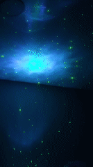 Person relaxes under projected starfield in Russian bedroom