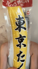 Woman displays yellow packaged item at Montenegro bar