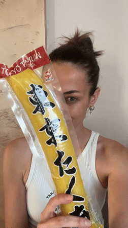 Woman displays yellow packaged item at Montenegro bar
