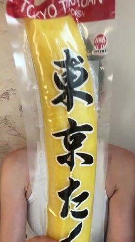 Woman displays yellow packaged item at Montenegro bar