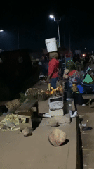Late-night street activity along a Bukuru roadside