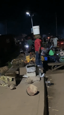 Late-night street activity along a Bukuru roadside