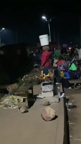 Late-night street activity along a Bukuru roadside