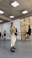 Ballet dancers practice routine exercises at studio