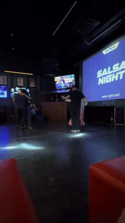 Couples enjoy salsa dancing at Colombo sports bar event