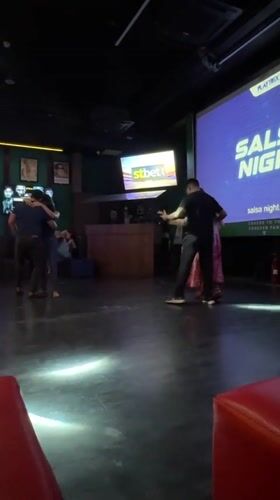 Couples enjoy salsa dancing at Colombo sports bar event
