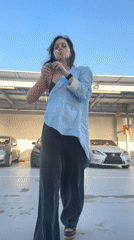 Woman smokes, applies face cream in Dubai parking garage
