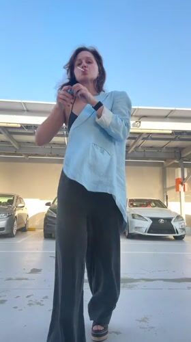 Woman smokes, applies face cream in Dubai parking garage