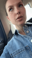 Woman records selfie video from car passenger seat in Moscow