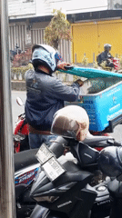 Morning traffic flows through a busy Lubuklinggau street