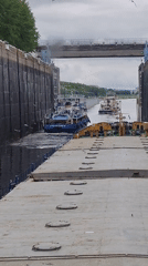 Ships Navigate Canal Lock System Through Brick Tower Gates