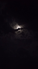 Nighttime church gathering features drumming under cloudy moonlit sky