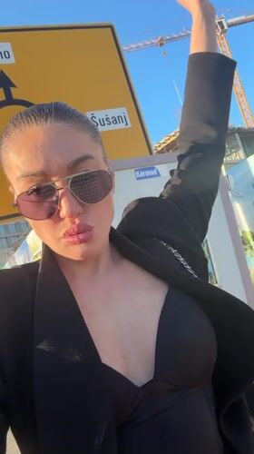 Woman films outdoor selfies in Bar, Montenegro Friday afternoon
