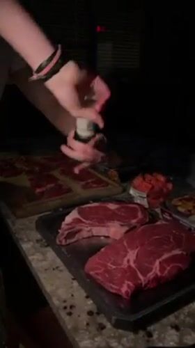 Evening steak preparation captured at Gainesville outdoor kitchen