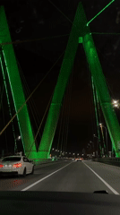 Night traffic observed on illuminated bridge in Kazan