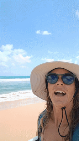Woman films beach selfie with boogie board in Luquillo