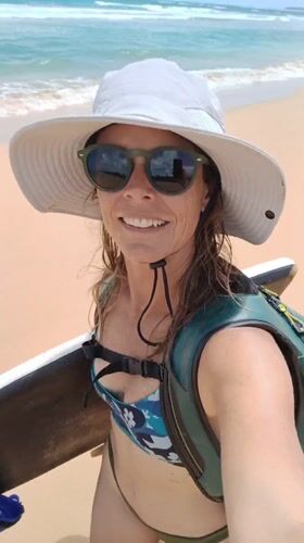 Woman films beach selfie with boogie board in Luquillo