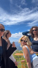 Women pose for photos at Montenegro mountain overlook