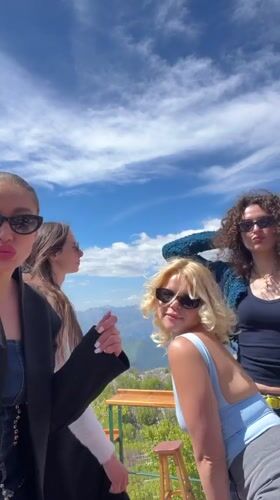 Women pose for photos at Montenegro mountain overlook